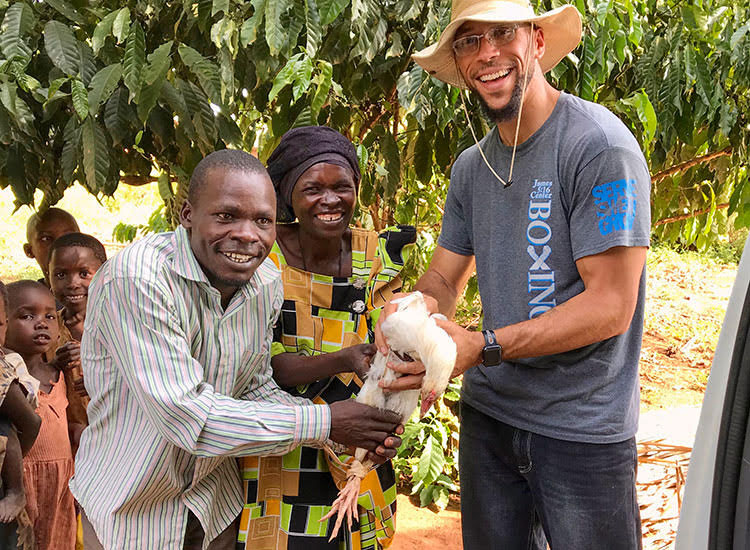 Picture of poor farmer in Africa giving chicken as gift