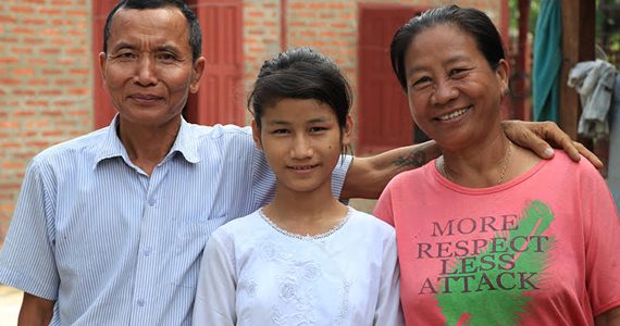 picture of child in myanmar with uncle and aunt, after being taken out of orphanage