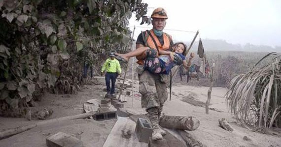 Picture of child being rescued after earthquake in Guatemala