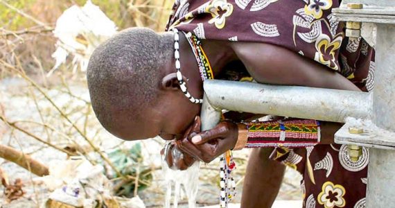 Picture of child in South Sudan drinking clean water
