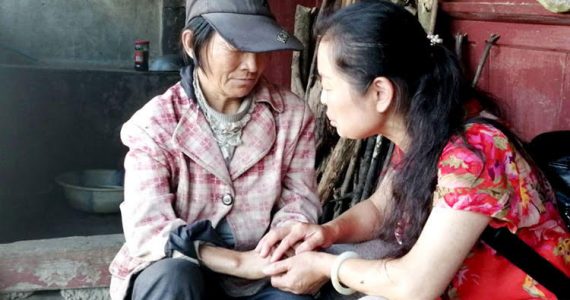 Picture of missionary praying with unreached person in China