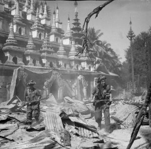 British soldiers patrol the ruins of Bahe, in Central Burma