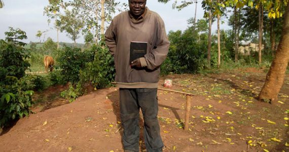 Picture of Maurice in East Africa holding his own Bible