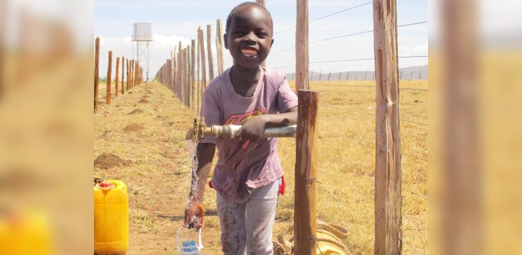 Little child in Kenya with clean drinking water