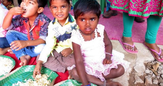 Children at a leprosy colony in Hyderabad, India eating