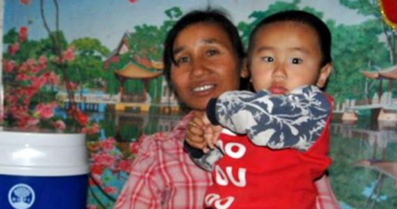 Sister Ai from unreached people group in China holding grandson