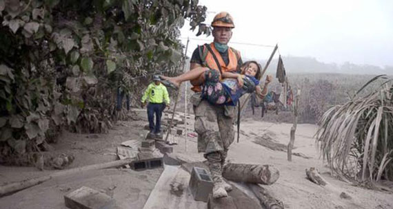 Picture of child being rescued after earthquake in Guatemala
