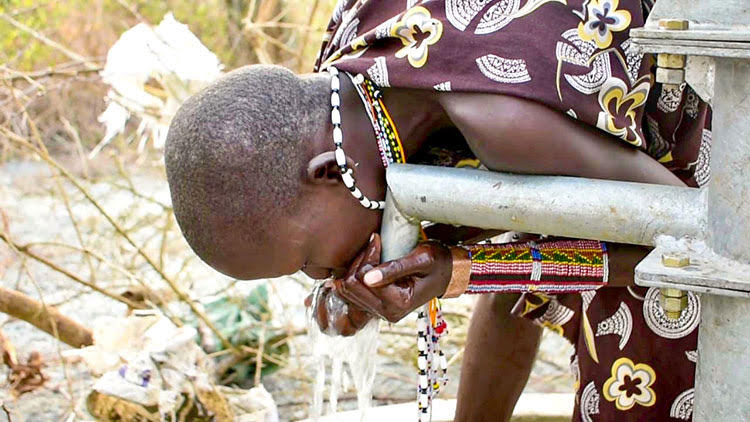 Picture of child in South Sudan drinking clean water