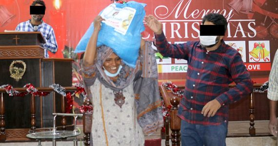 Picture of a believer in Pakistan receiving relief goods