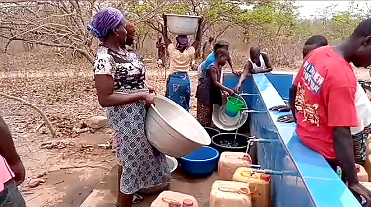 Picture of people in Nigeria filling their containers with clean water