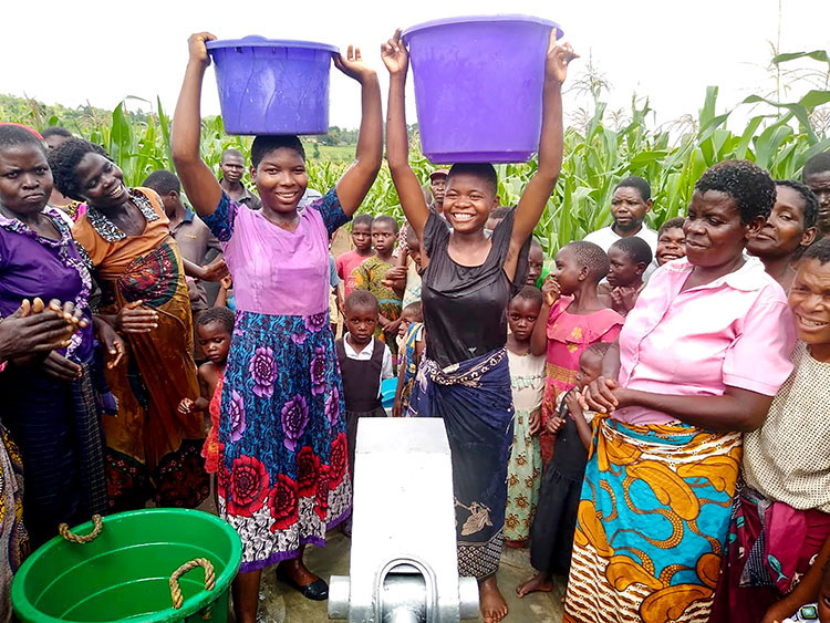 Image of villagers in Malawi with safe water