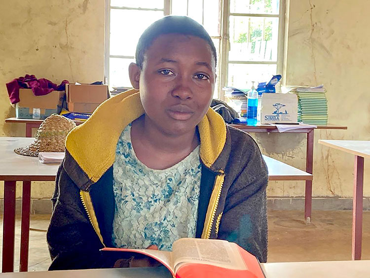 Image of Tabitha from Rwanda reading Bible