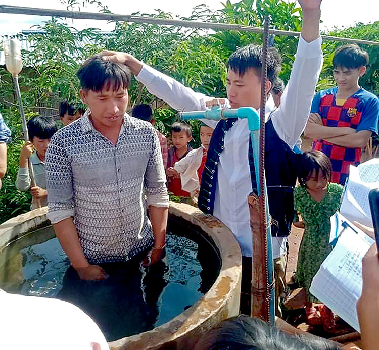 Image of villagers being baptized